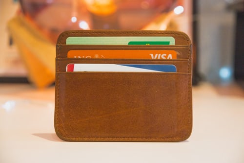 atm cards in a brown purse