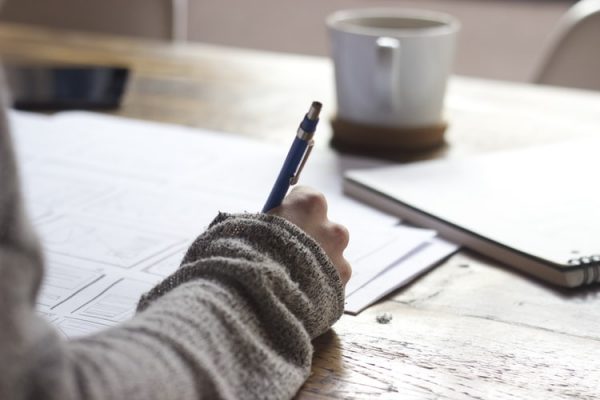 girl writing on a table