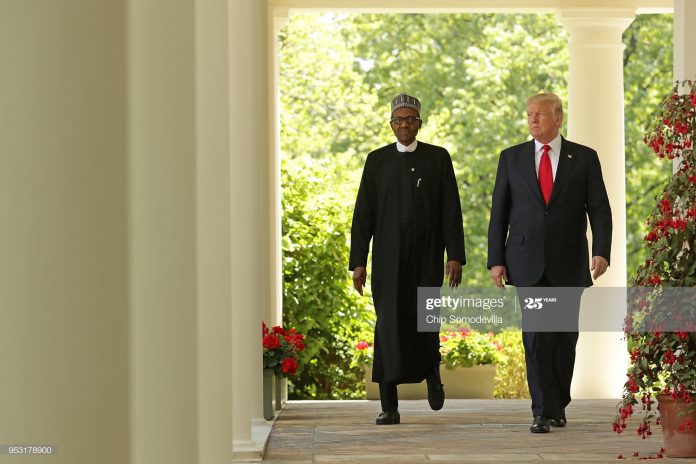 Buhari standing next to Trump