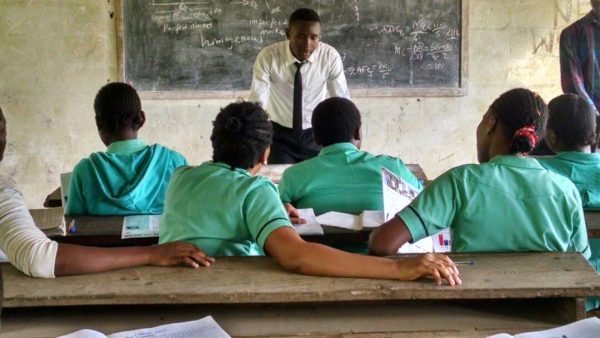 Teenager teaching school mates