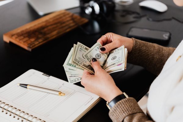 Man counting money on a table 