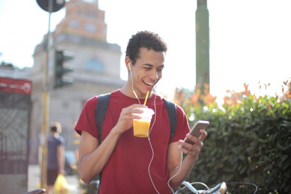 student is happy after making money on his phone